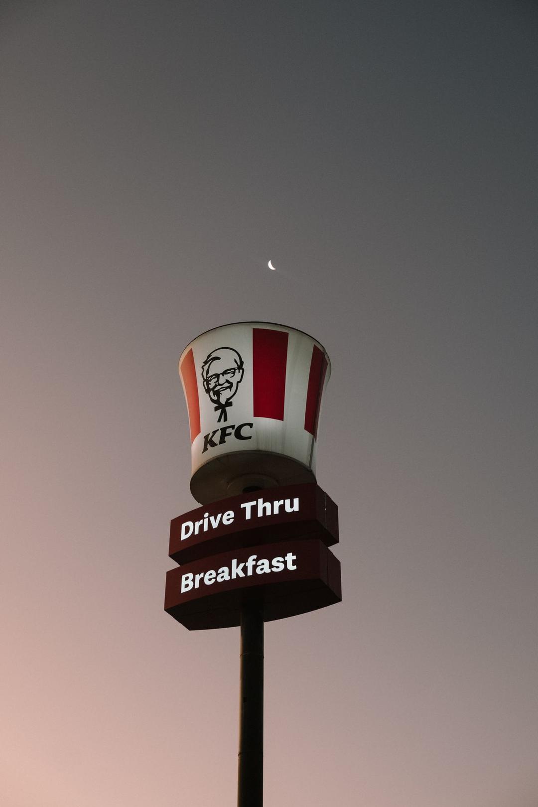 A KFC sign lit up at twilight