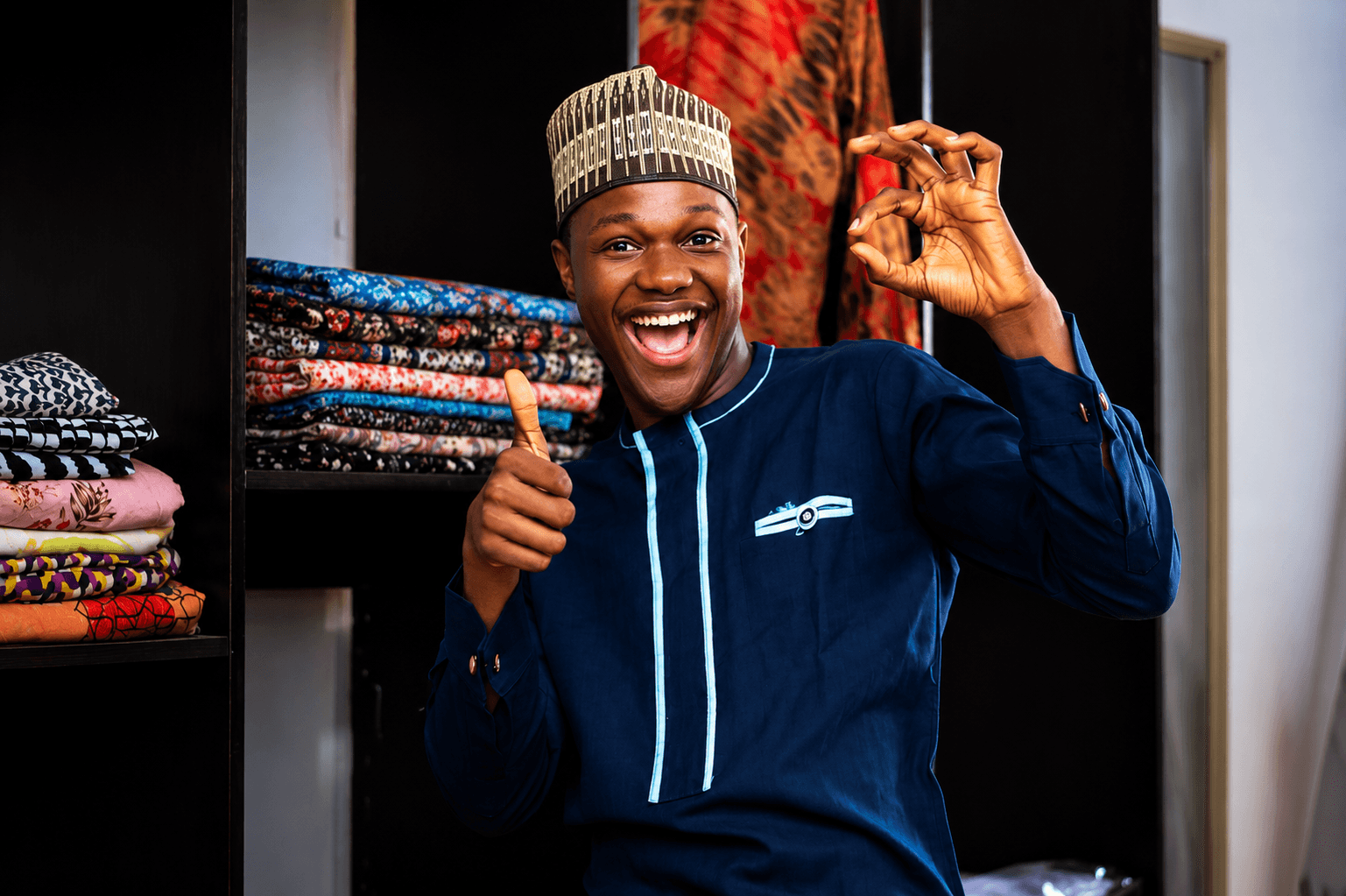 A shopper smiling while browsing a fabric stall