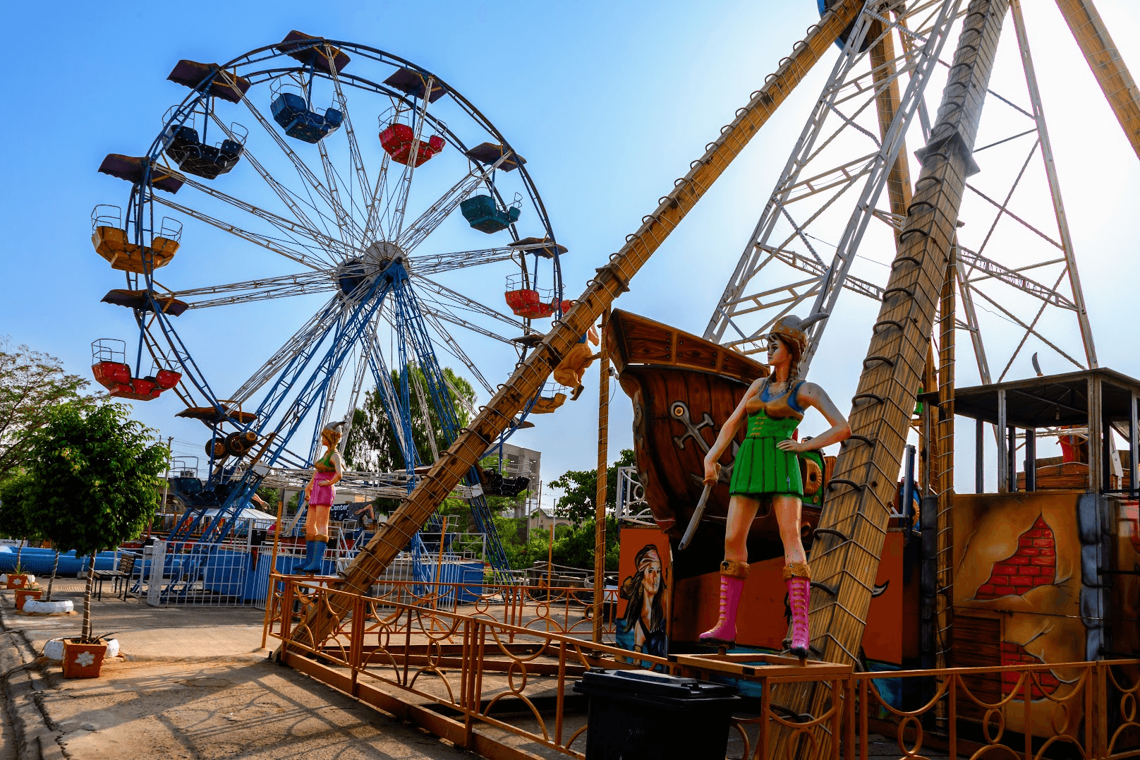 A Ferris wheel and pirate-ship swing ride at ABM Mall's fairground